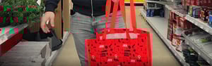 A customer is carrying a NovaBrix Ace Hardware CMN carry bag
