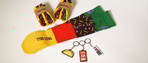 Colourful Taco Bell socks packaged as a taco and 3 keyrings created by Novelli